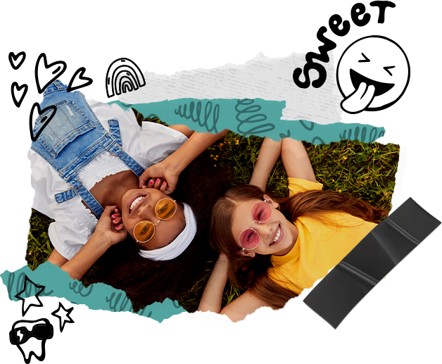 two kids laying on grass smiling