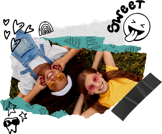 two kids laying on grass smiling